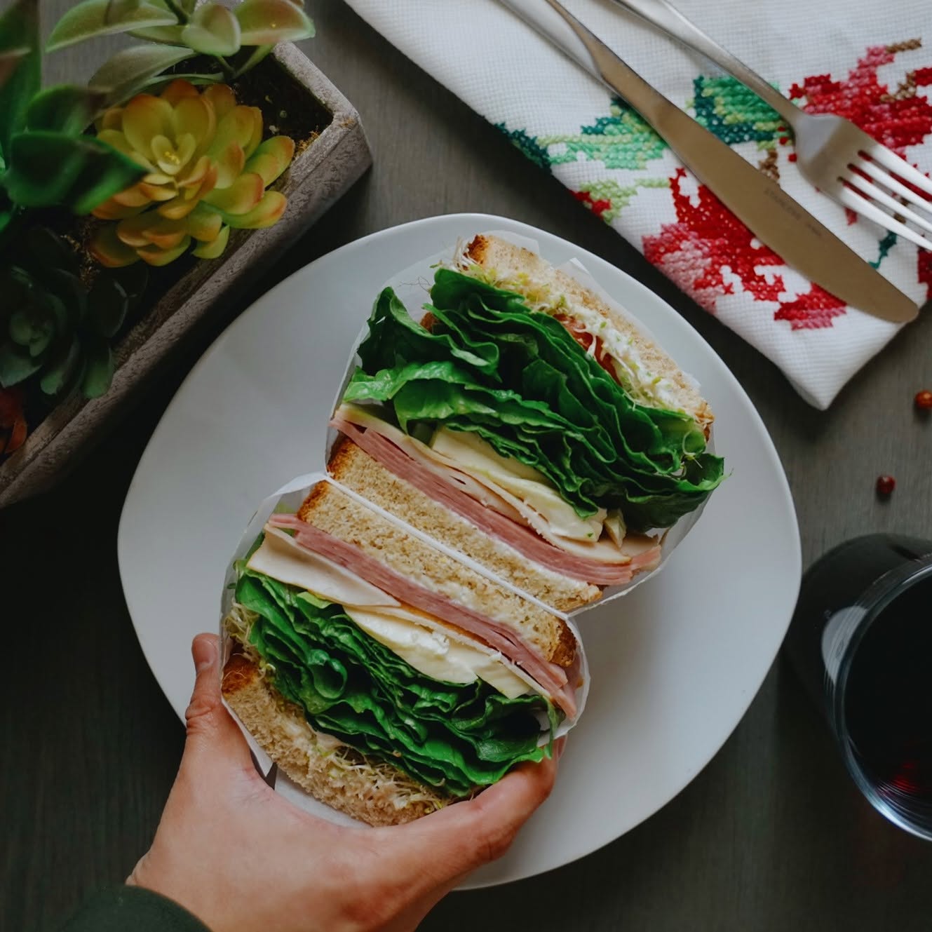 Ham and turkey sandwich on 7-grain bread with lettuce, swiss cheese and sprouts